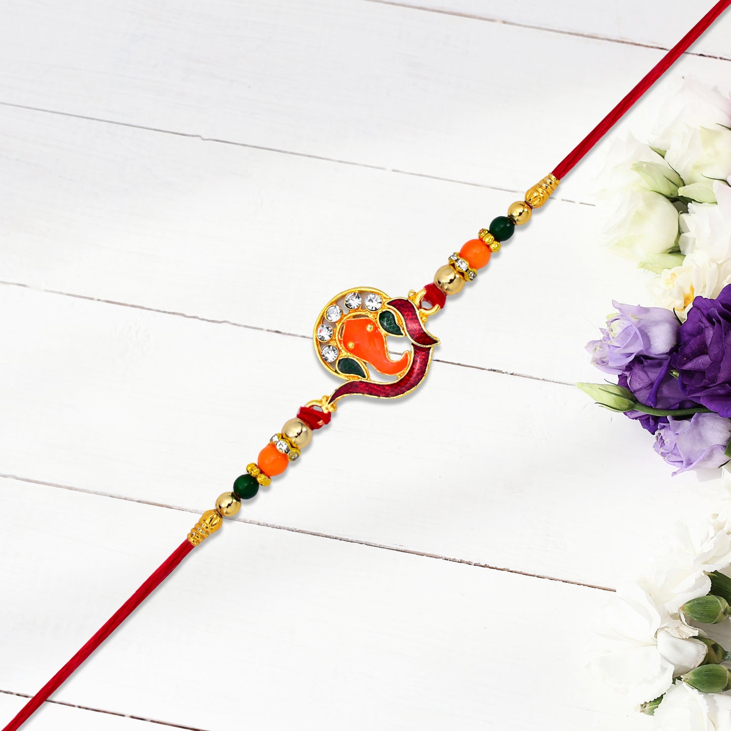 Golden Ganesha Rakhi With Red-green Beads And Stone Detailing