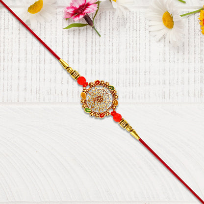 Intricately Designed Circular Rakhi With Multicolor Accents And Red Thread For Rakshabandhan