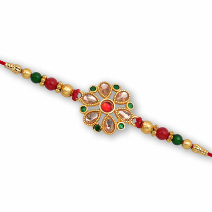Floral Kundan Rakhi With Red-green Beads And Golden Finish
